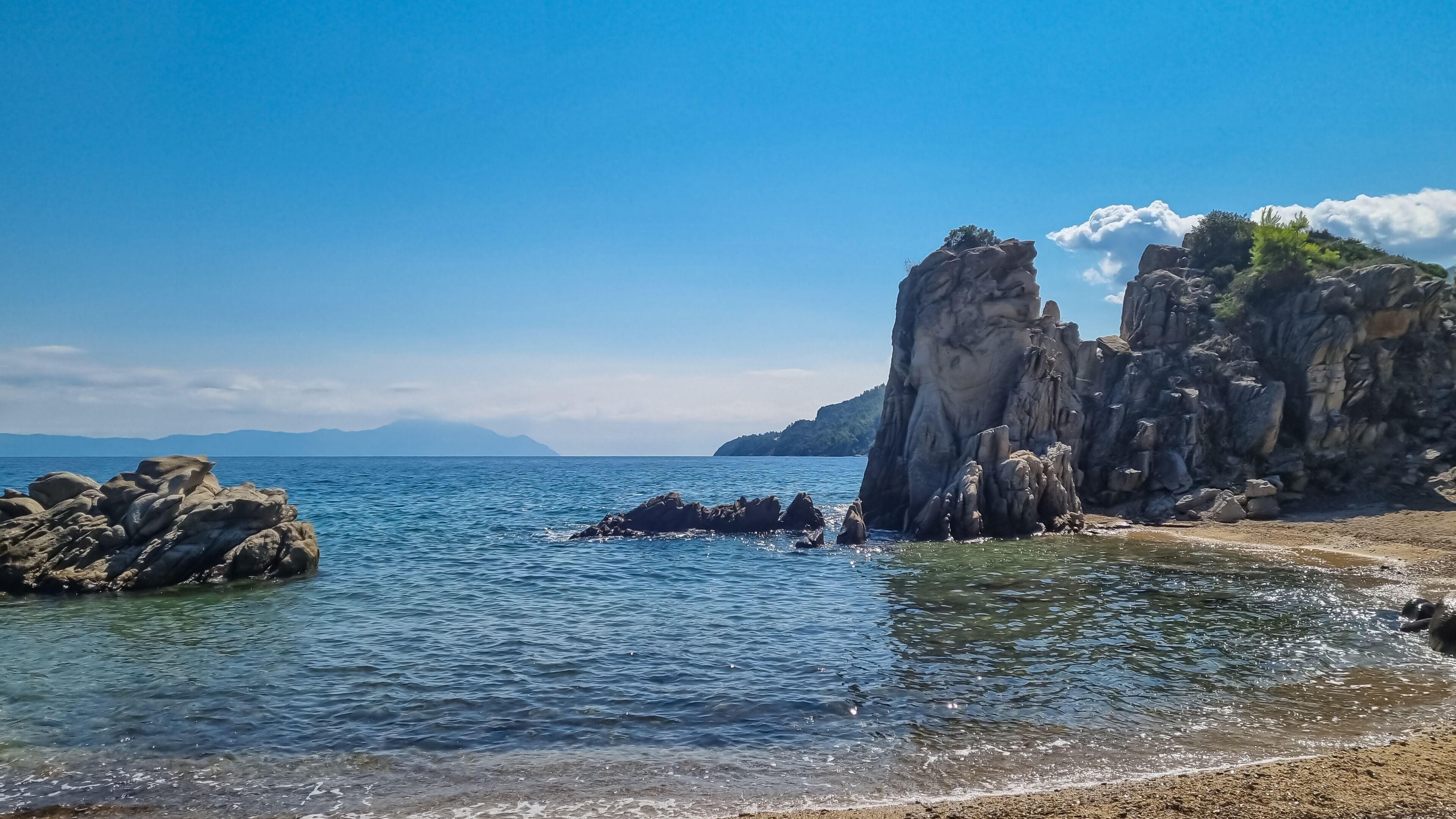 Panoramic view on calm Fava sand beach near Vourvourou, Greek peninsula Sithonia, Chalkidiki (Halkidiki), Greece, Europe. Summer vacation at Aegean Mediterranean Sea. Unique natural rock formations