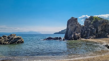 Panoramic view on calm Fava sand beach near Vourvourou, Greek peninsula Sithonia, Chalkidiki (Halkidiki), Greece, Europe. Summer vacation at Aegean Mediterranean Sea. Unique natural rock formations