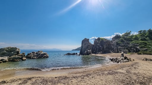 Panoramic view on calm Fava sand beach near Vourvourou, Greek peninsula Sithonia, Chalkidiki (Halkidiki), Greece, Europe. Summer vacation at Aegean Mediterranean Sea. Unique natural rock formations