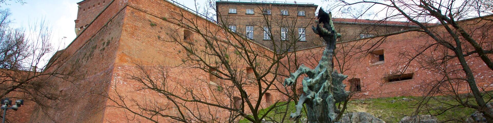 Dragon\'s Den featuring a statue or sculpture as well as a small group of people