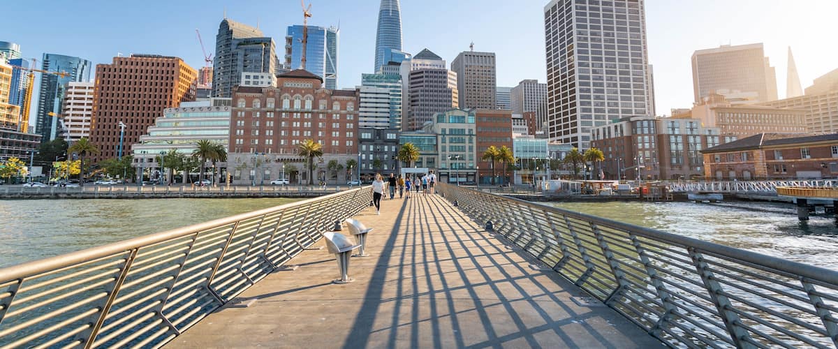 Embarcadero Plaza featuring a bridge, a sunset and a river or creek