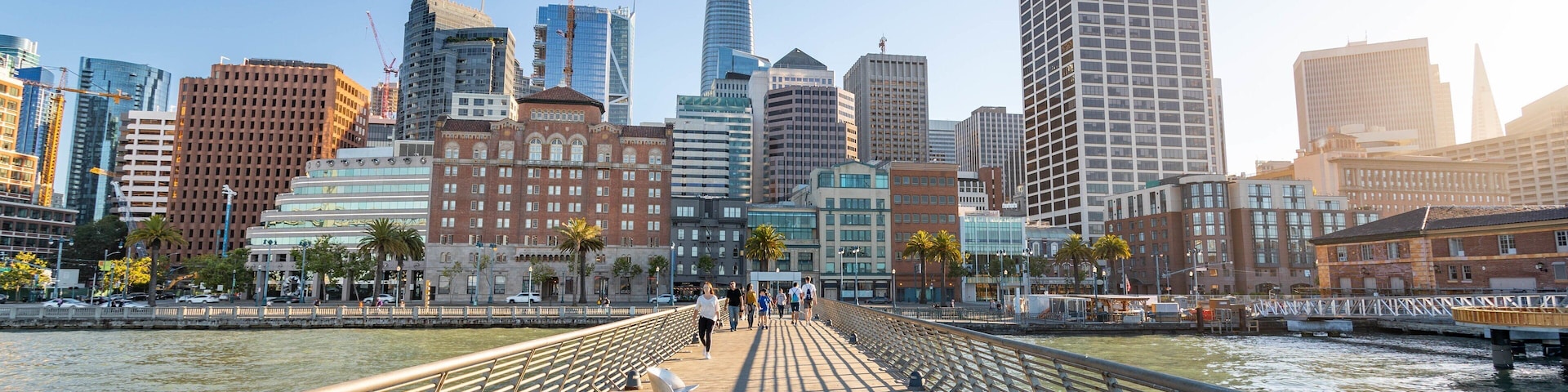 Embarcadero Plaza featuring a bridge, a sunset and a river or creek
