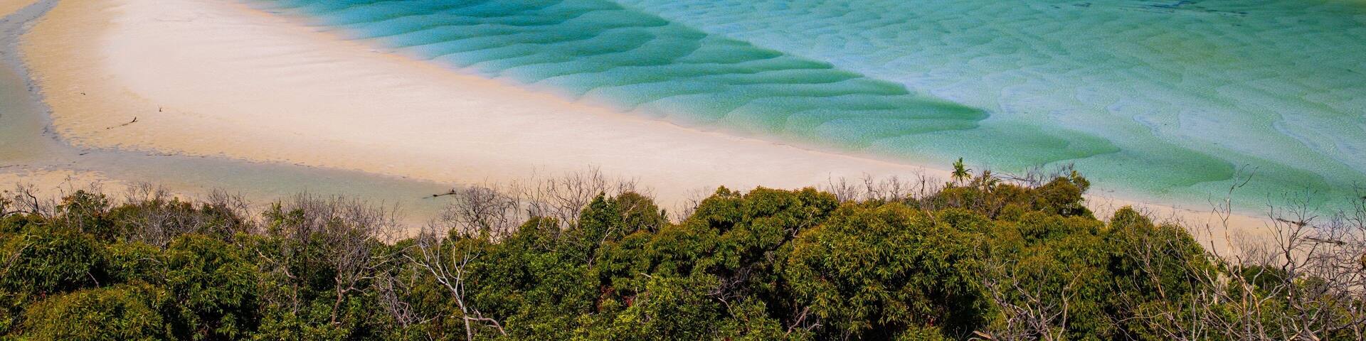 Whitehaven Beach which includes general coastal views, a river or creek and landscape views