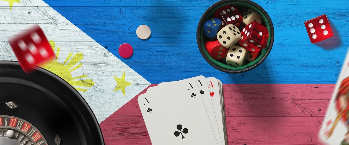 Philippines casino theme. Aces in poker game, cards and chips on red table with national flag background. Gambling and betting.