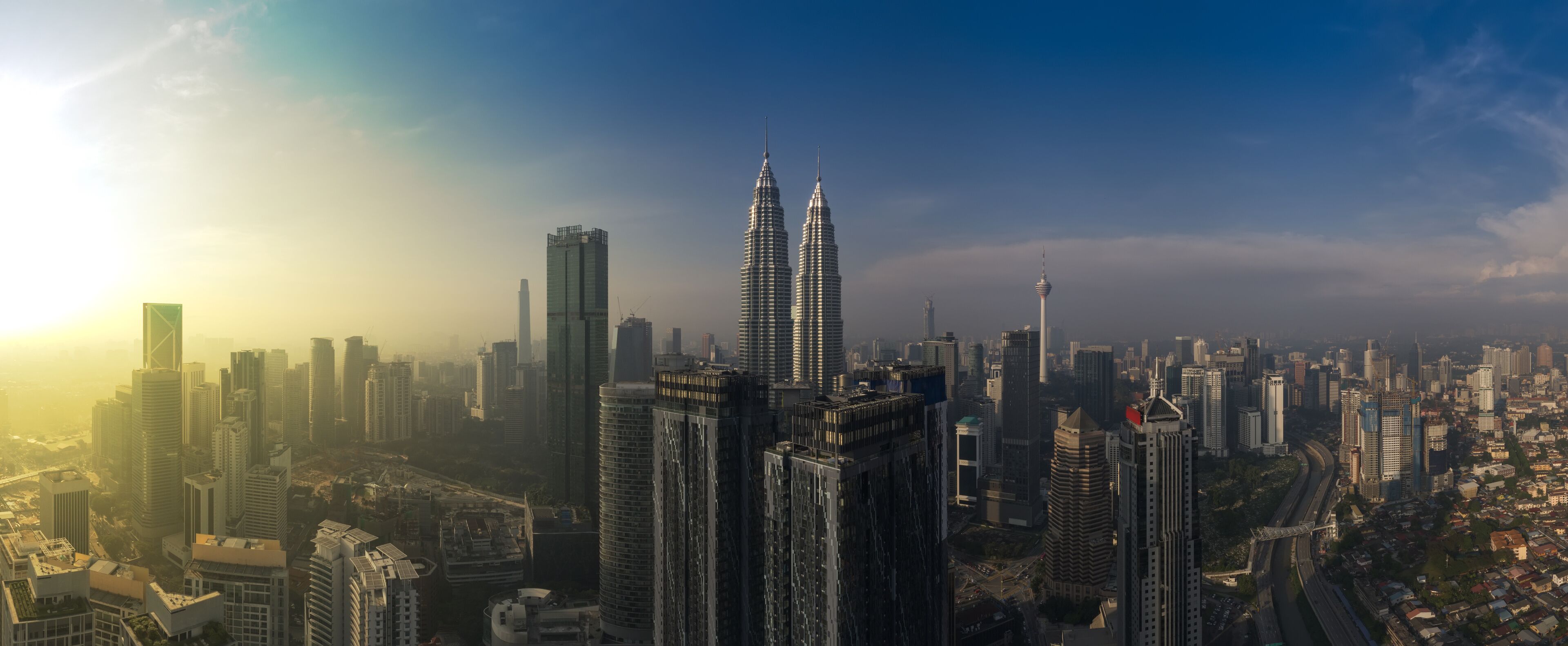 kuala lumpur buildings with dramatic sunrise aerial panorama shot
