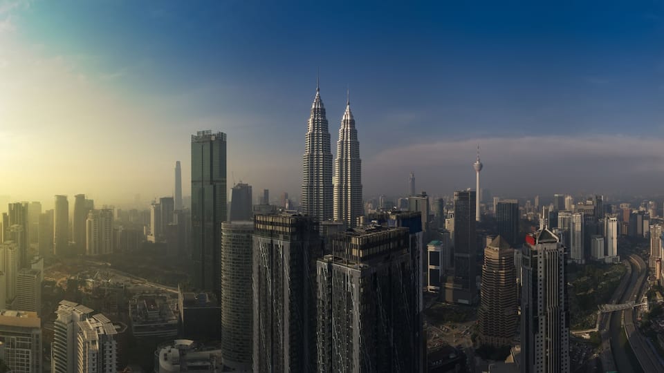 kuala lumpur buildings with dramatic sunrise aerial panorama shot