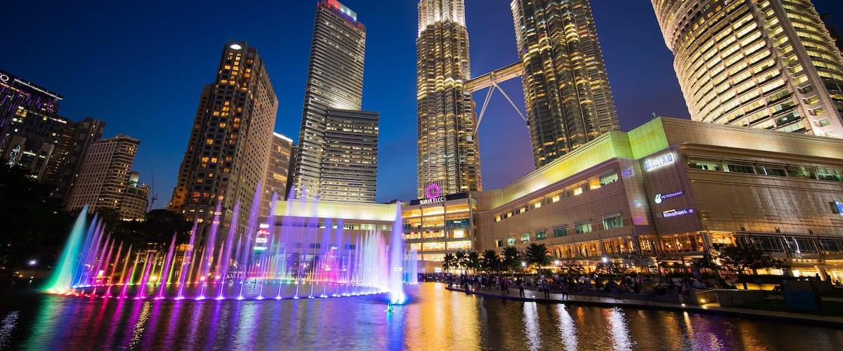 KLCC Park which includes night scenes, a city and a fountain