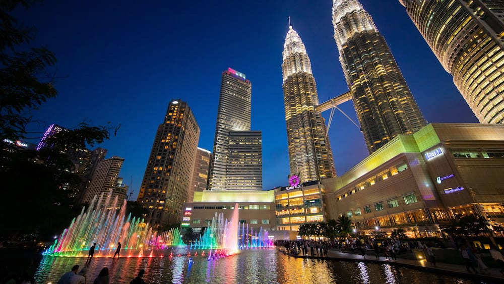 KLCC Park featuring a high rise building, night scenes and a fountain