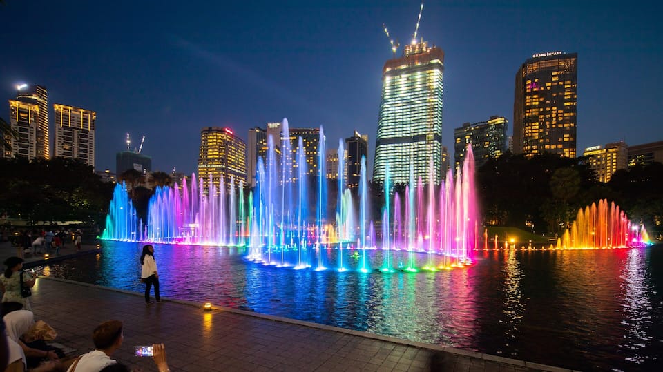 KLCC Park featuring a city, night scenes and a fountain