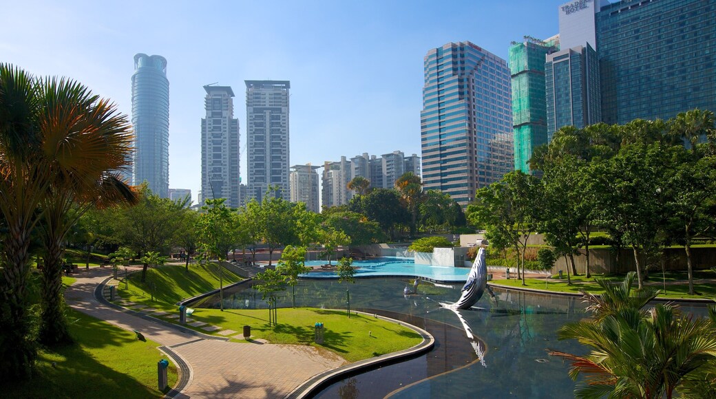 KLCC Park featuring a garden, a pond and a high rise building
