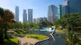 KLCC Park featuring a garden, a pond and a high rise building