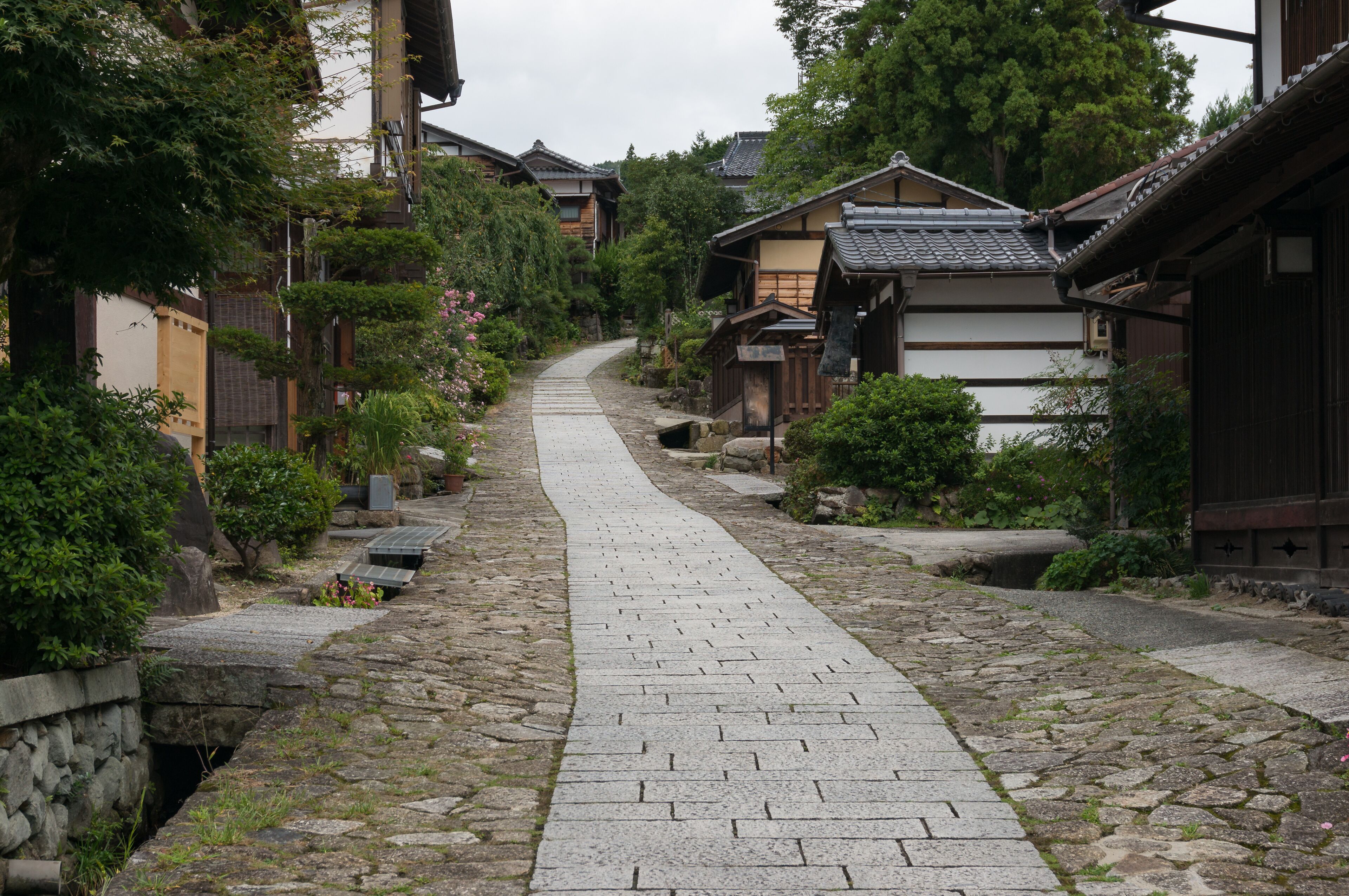 Stone lined street with traditional Japanese buildings. Magome, Japan