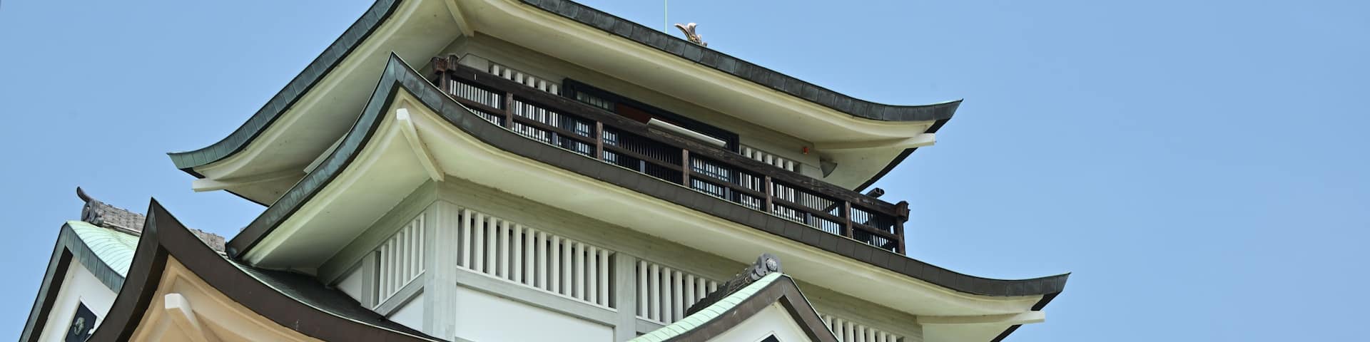 A traditional Japanese building with multiple tiers and a curved roof.