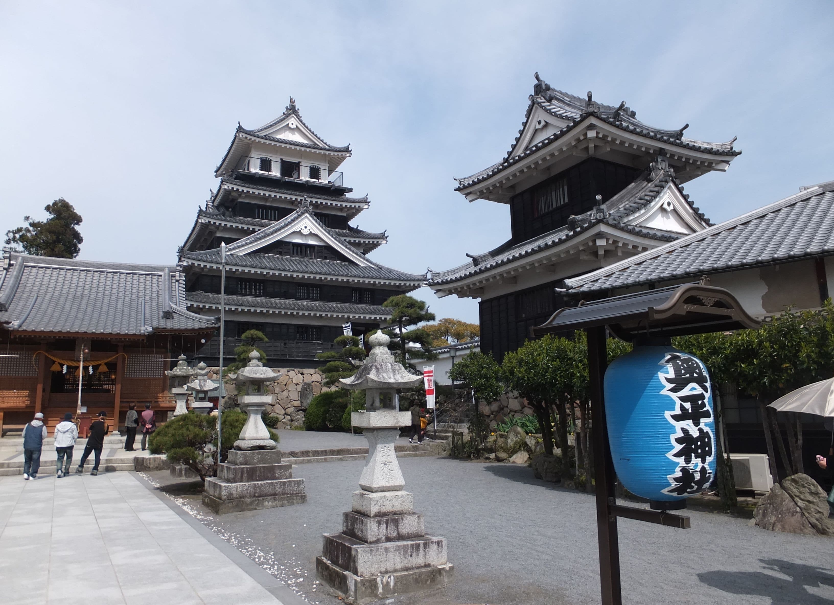 Traditional Japanese architecture with tiered roofs and stone lanterns.