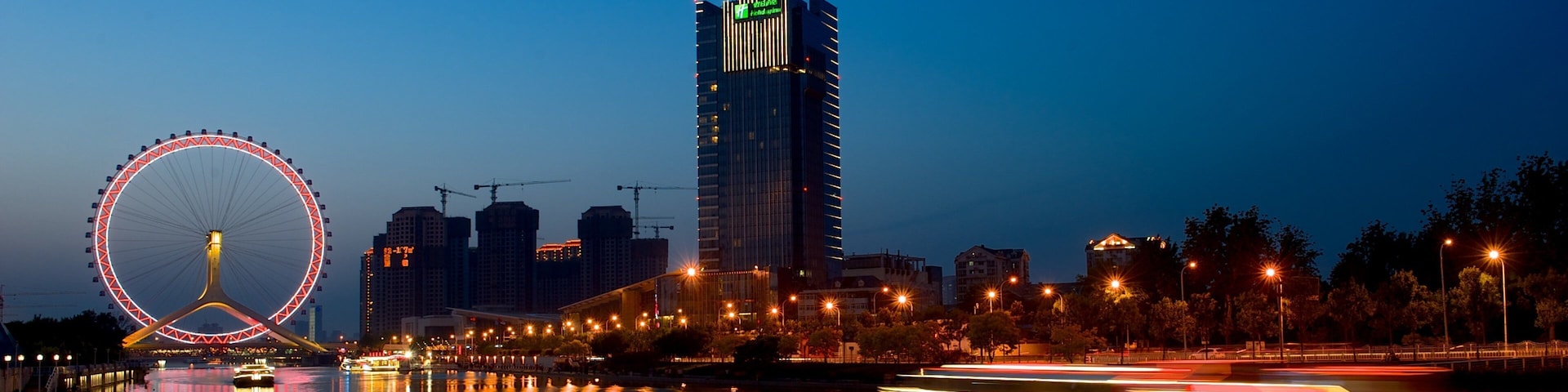 Tianjin Eye showing night scenes, a river or creek and central business district