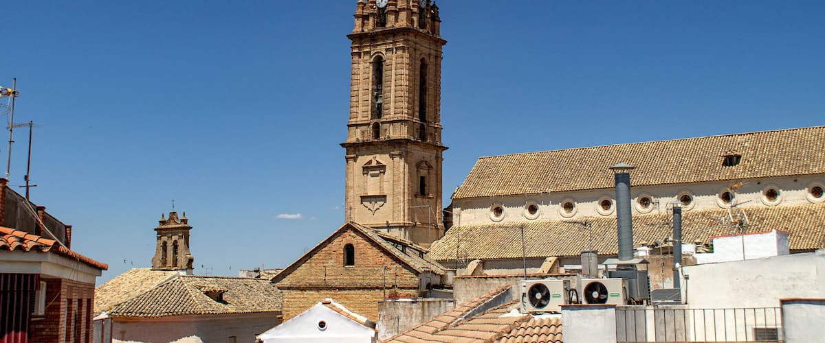 A historic church with a tall bell tower and a tiled roof.