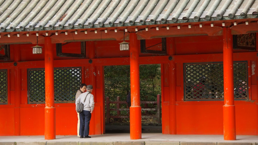 Hakone Shrine featuring a temple or place of worship as well as a small group of people