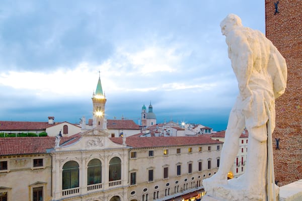 Piazza dei Signori showing night scenes and a statue or sculpture