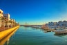 view of the Agadir marina full of tourists, boats and yachts at sunset