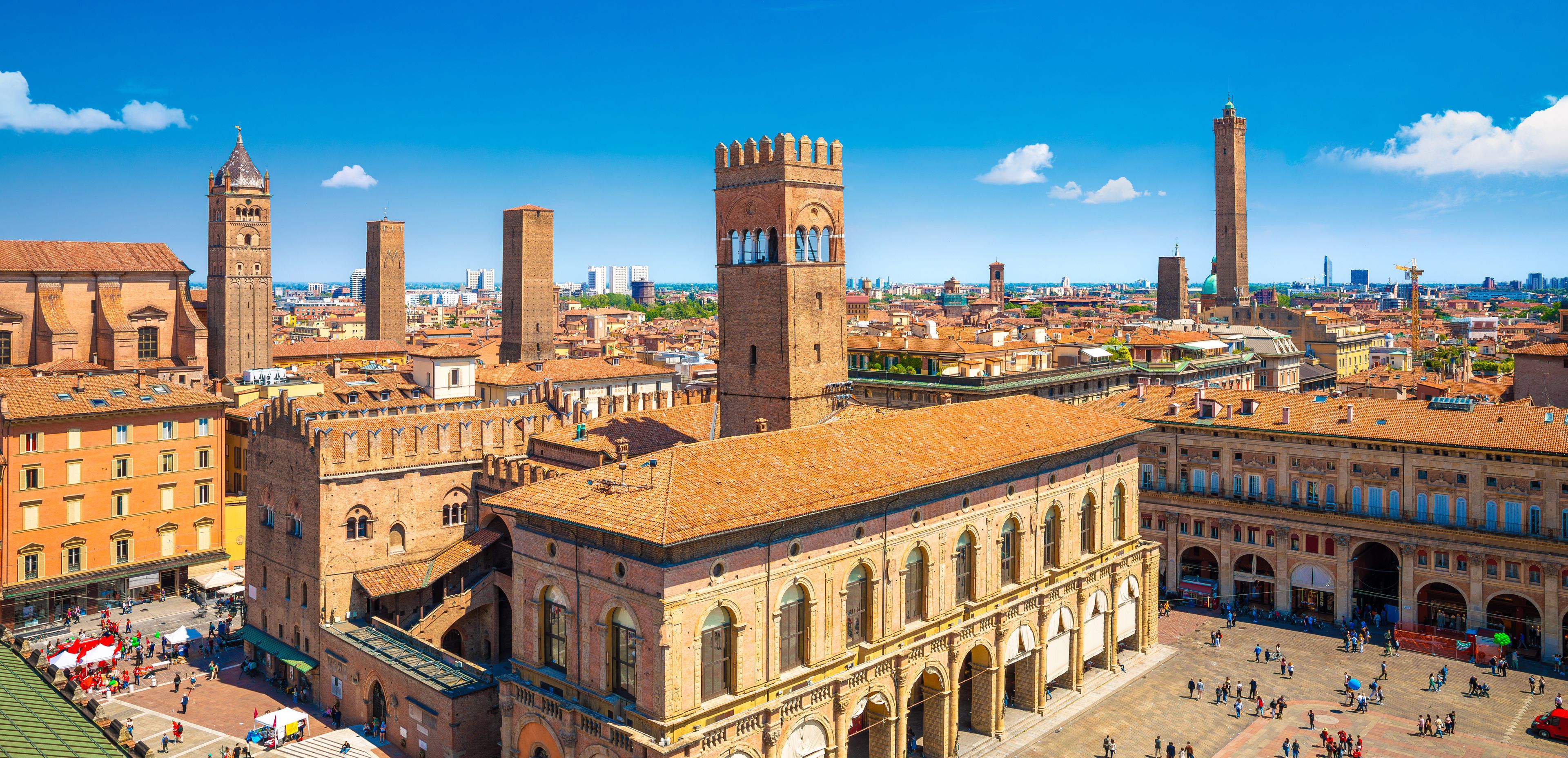 A historic cityscape with prominent towers and a central square.