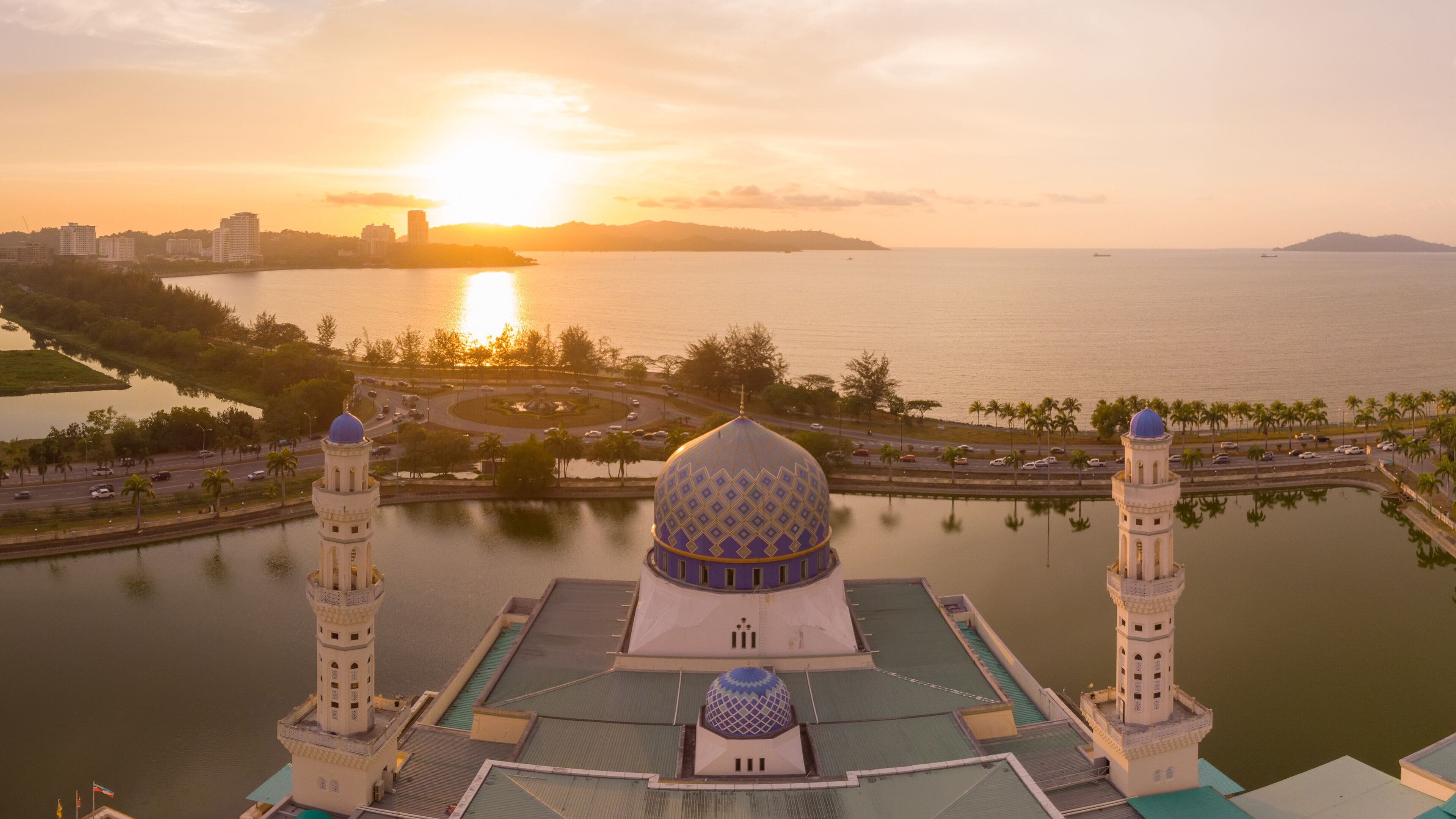 Aerial Drone image of beautiful mosque and the most famous tourist spot Likas Mosque(Masjid Bandaraya Likas), Kota Kinabalu, Sabah, Malaysia. during Sunset