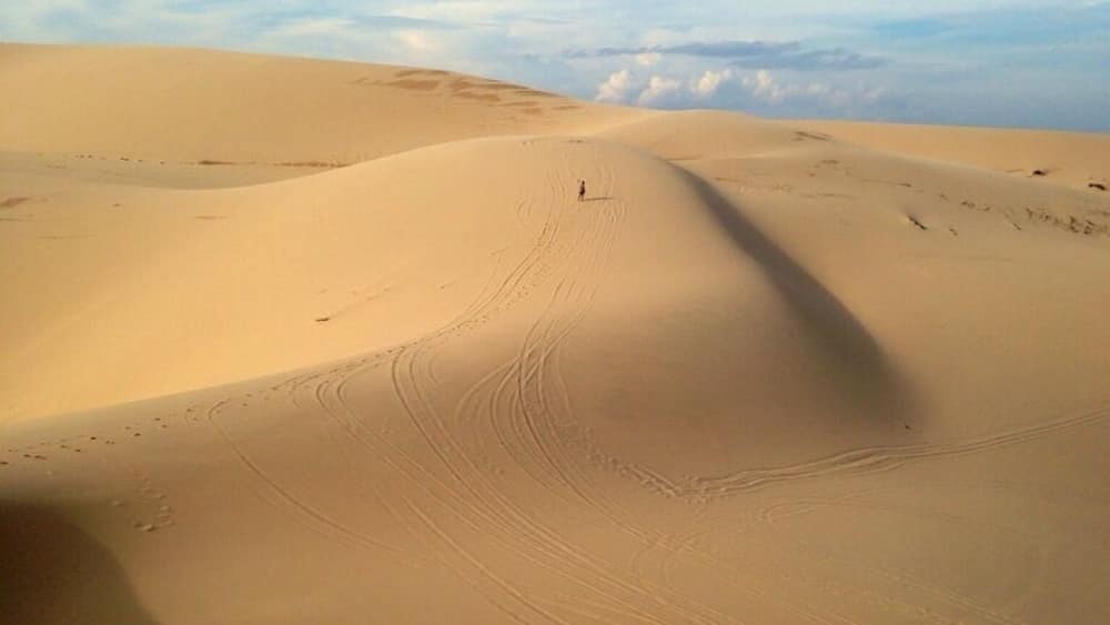This was the beautiful views of the white sand dunes about 40km from Mui Ne. We did an afternoon trip with Muine Backpackers travel and tour agent. We all went in a Russian Jeep to the Fairy Stream, views overlooking some fishing boats (unfortunately a very polluted beach), then onto the white sand dunes as seen here. After about an hour of running up/down the dunes we went for a sunset at the red sand dunes. All of this for $7 per person. We wanted to rent a scooter but after seeing the roads/roadwork on the way to the white sand dunes we were happy we didn't. Terrain for a jeep or off-road bike. The only downfall was they overbooked the tour and it was a tight squeeze in the back of the Jeep. Overall it was a good trip which combined everything you need to see in Mui Ne or surrounding area. Our recommendation would be to see the White sand dunes and then a sunset at the red sand dunes. Sliding down the dunes on plastic boards the local kids try and sell you for about 25000-40000 dong don't work and ours broke. There are no sand boards to rent unfortunately. #roadtrip