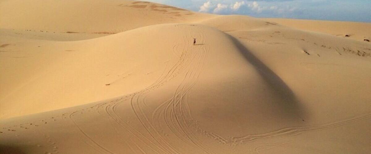 This was the beautiful views of the white sand dunes about 40km from Mui Ne. We did an afternoon trip with Muine Backpackers travel and tour agent. We all went in a Russian Jeep to the Fairy Stream, views overlooking some fishing boats (unfortunately a very polluted beach), then onto the white sand dunes as seen here. After about an hour of running up/down the dunes we went for a sunset at the red sand dunes. All of this for $7 per person. We wanted to rent a scooter but after seeing the roads/roadwork on the way to the white sand dunes we were happy we didn't. Terrain for a jeep or off-road bike. The only downfall was they overbooked the tour and it was a tight squeeze in the back of the Jeep. Overall it was a good trip which combined everything you need to see in Mui Ne or surrounding area. Our recommendation would be to see the White sand dunes and then a sunset at the red sand dunes. Sliding down the dunes on plastic boards the local kids try and sell you for about 25000-40000 dong don't work and ours broke. There are no sand boards to rent unfortunately. #roadtrip