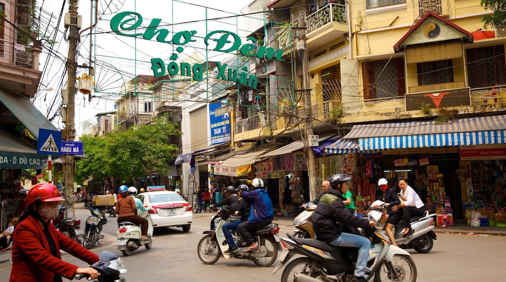 Dong Xuan Market which includes street scenes, a city and motorbike riding