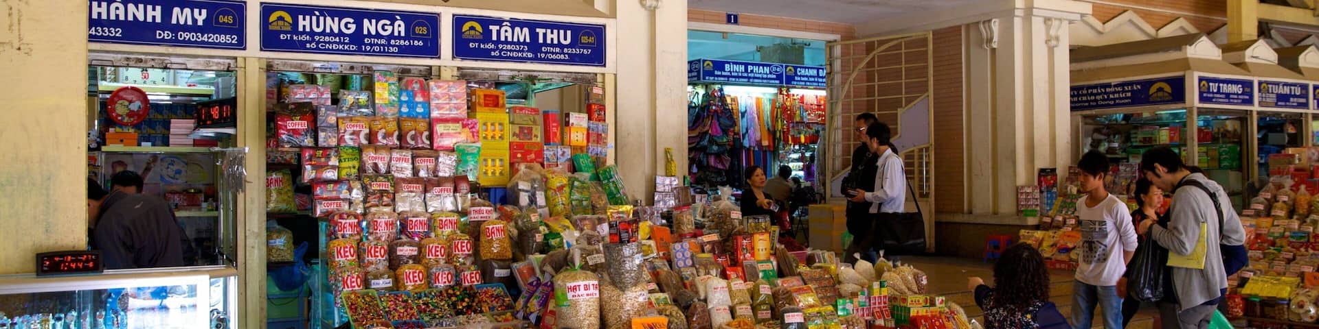 A market with various stalls selling snacks and beverages.
