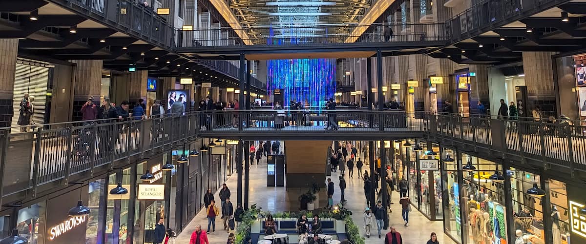 Shoppers explore the retail space within the repurposed turbine hall of the Battersea Power Station