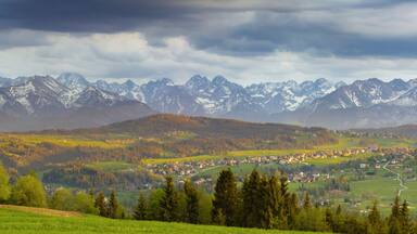 A mountainous landscape with a village nestled in the valley.