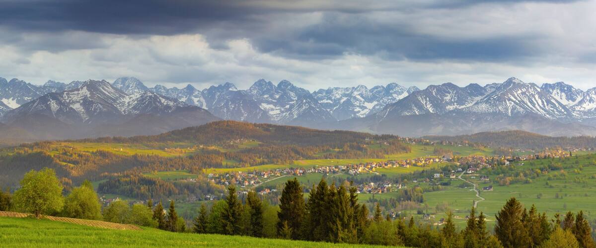 A mountainous landscape with a village nestled in the valley.