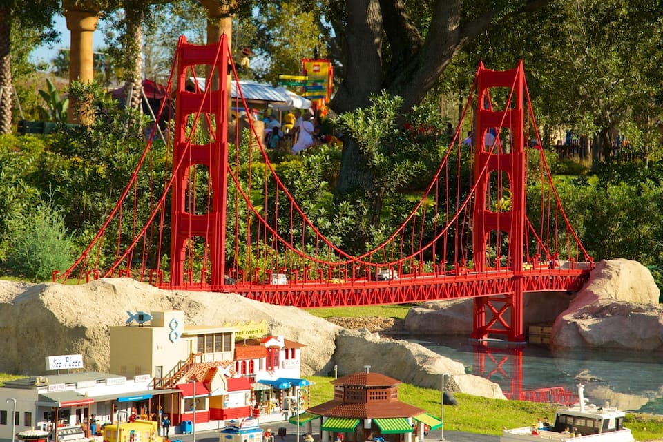 A model of the Golden Gate Bridge with surrounding miniature buildings and greenery.
