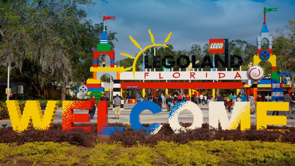 A LEGO-themed welcome sign with 'LEGO FLORIDA' and 'WELCOME' in large letters, surrounded by greenery.