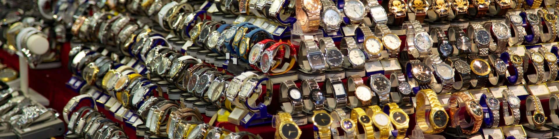 Numerous stylish watches displayed at the Festival Flea Market in Pompano Beach, Florida during a busy shopping day