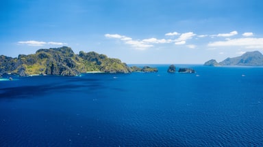 A coastal landscape with rocky islands and clear blue waters.