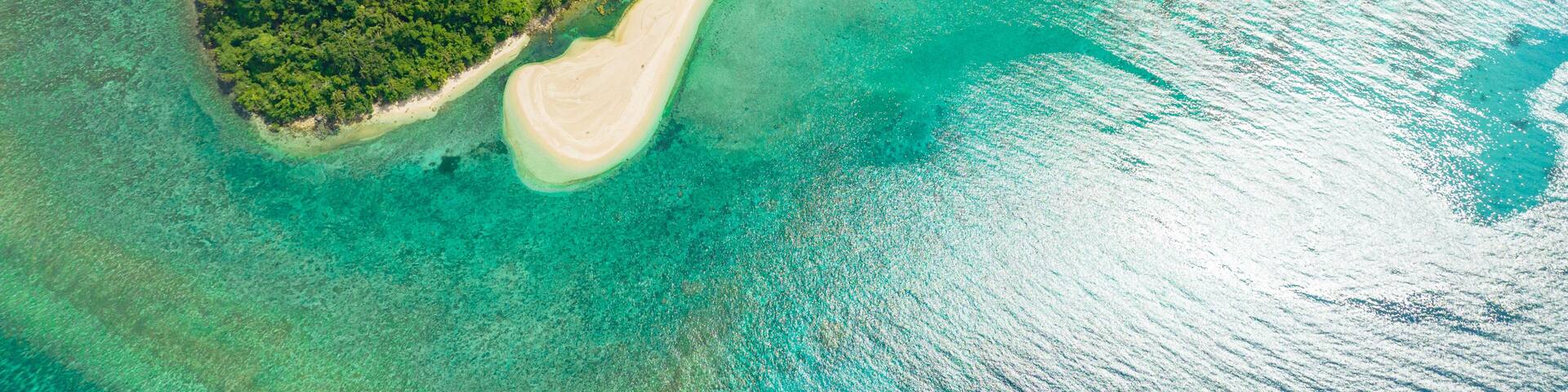 Aerial drone of island in the blue sea with atoll and the beach. Agutaya island, Philippines.