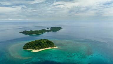 Aerial drone of tropical islands with beach and blue sea. Agutaya and Danjugan islands, Philippines.