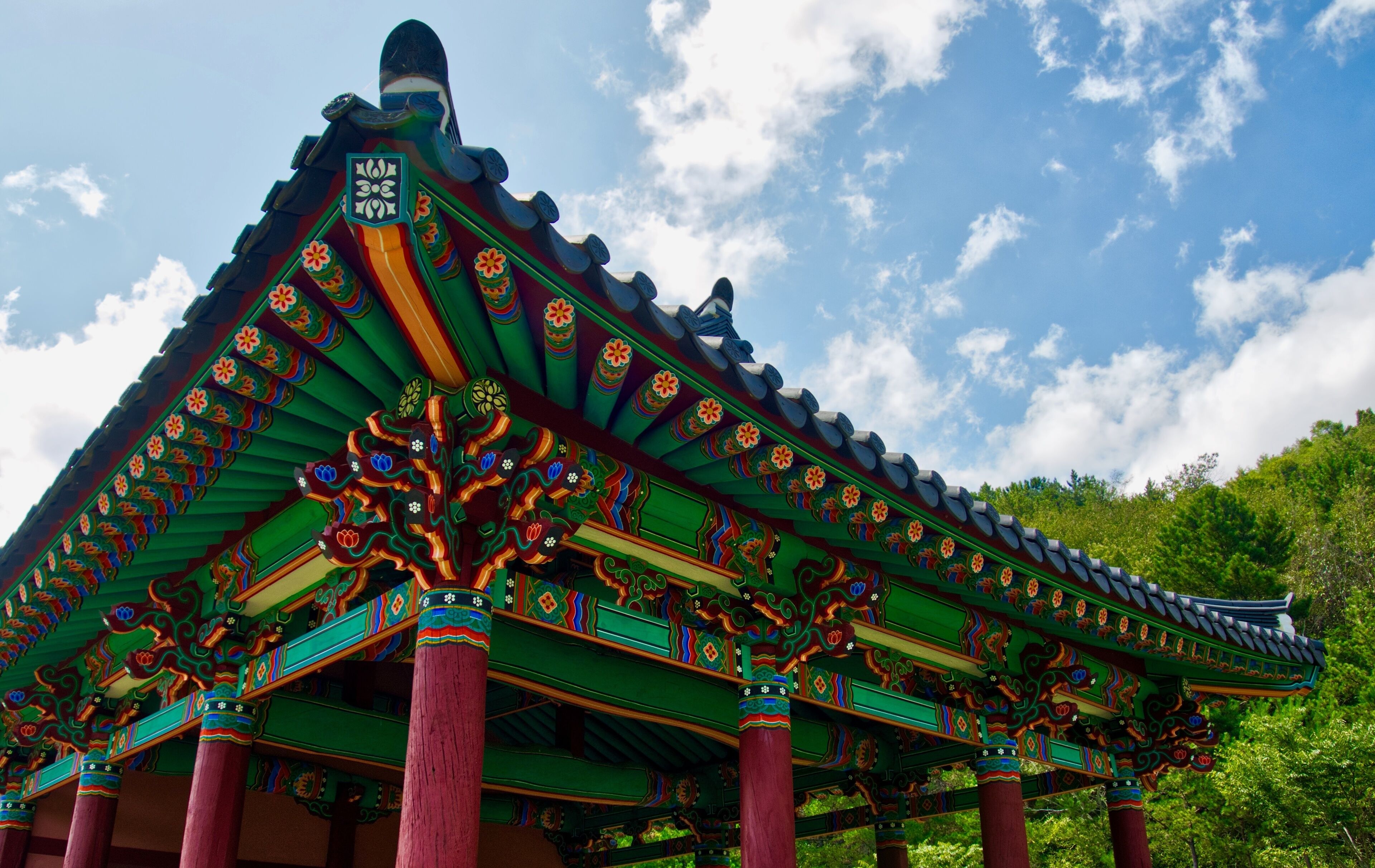 A traditional Korean pavilion with ornate roof decorations and vibrant colors.