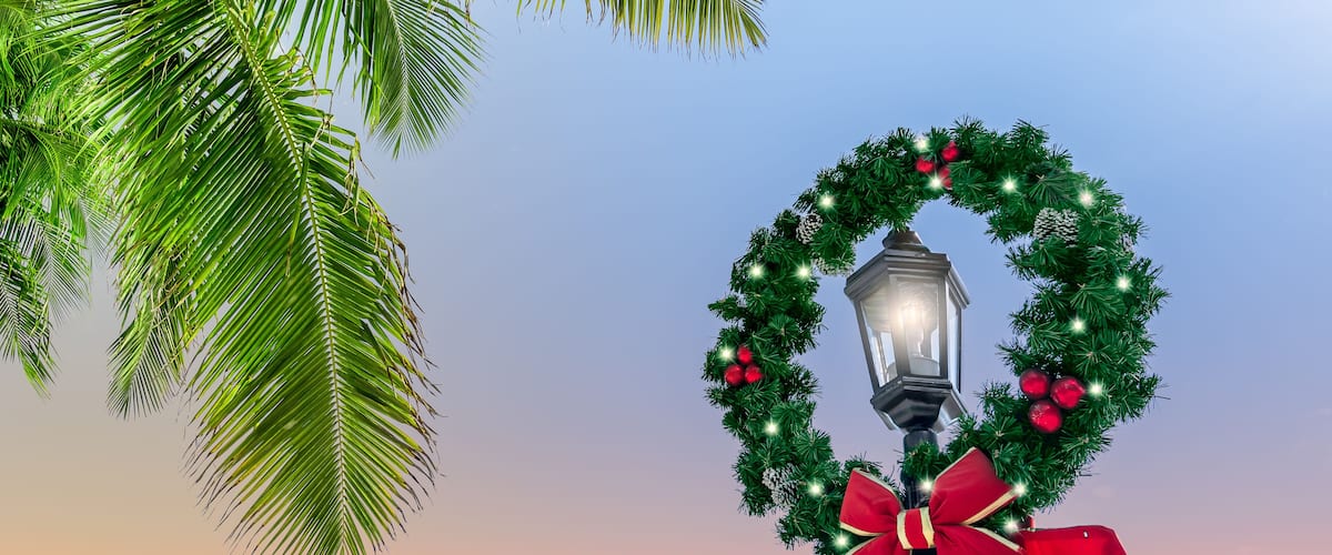 A street lamp adorned with a Christmas wreath and bow.