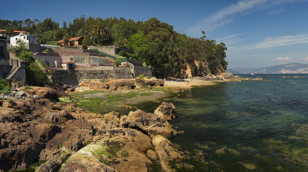 Panoramic of a small beach between Cangas and Moaña. Transparent green water with Vigo City in the background
