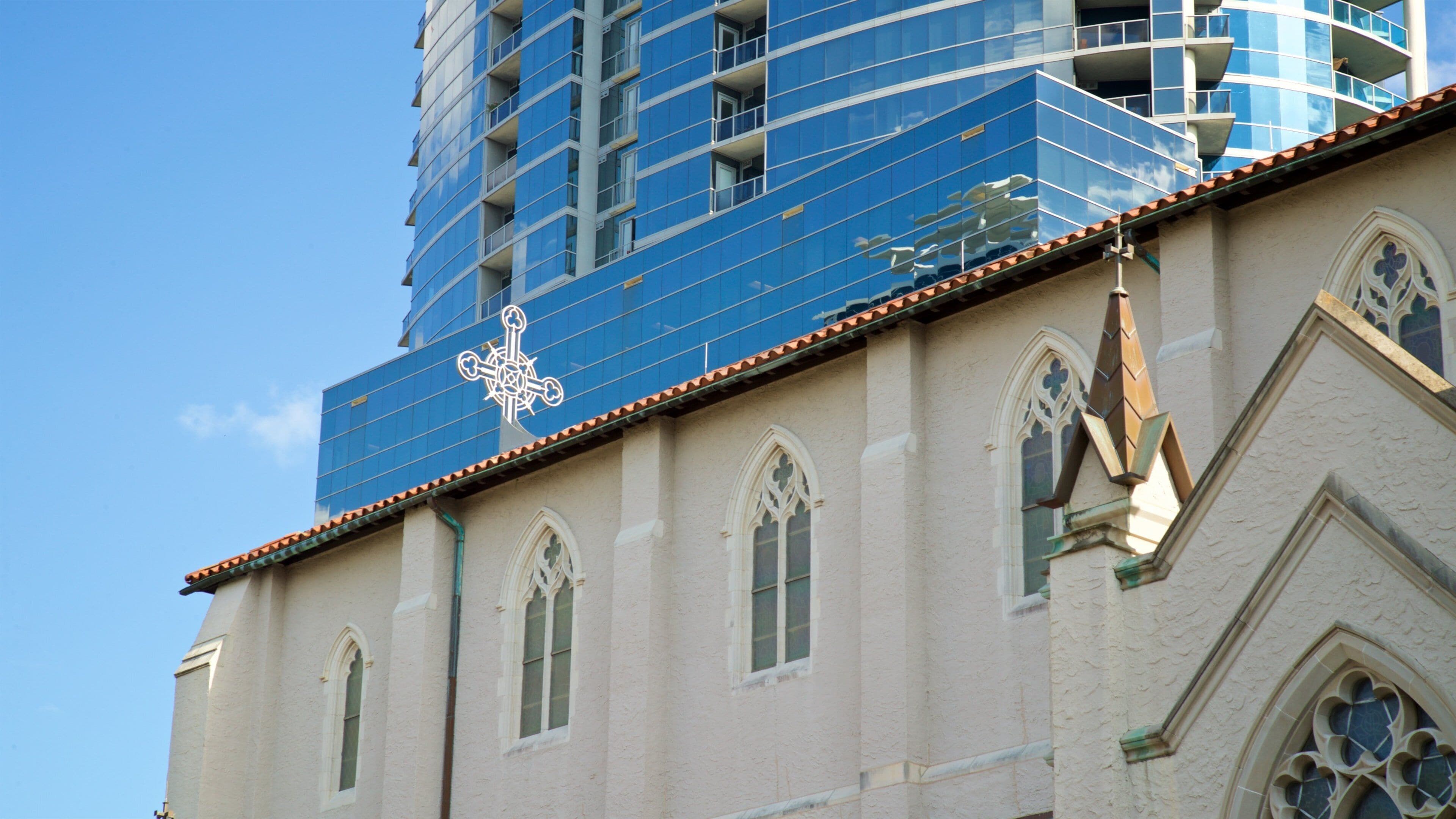 Cathedral Church of St. Luke showing a skyscraper and a church or cathedral