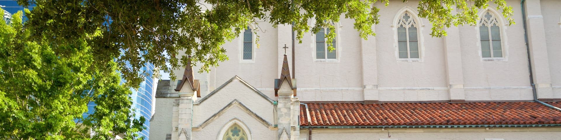 A church with a red-tiled roof and arched windows.