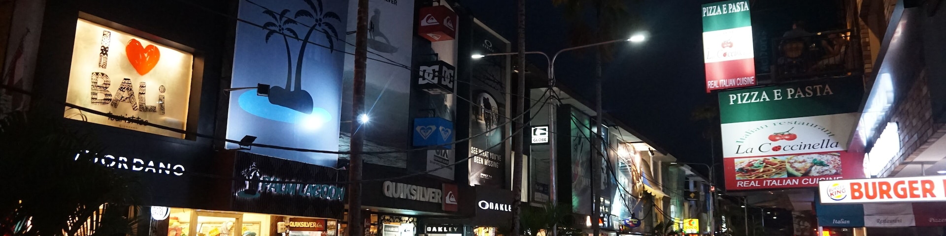 A view on the Kuta Square Shopping Street at Night, located in the cnetral area of Kuta, Bali, Indonesia. The view includes many shops and restaurants located along this street.