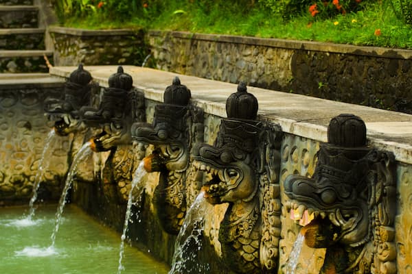 Thermal water shooting into a bathing pool from the mouths of dragon statues at a hot springs in Banjar, Bali, Indonesia. Horizontal; Shutterstock ID 65274505; Purchase Order: -