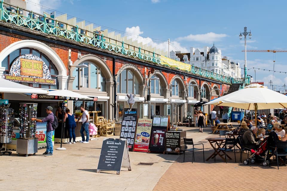 A bustling street market with various food stalls and shops.