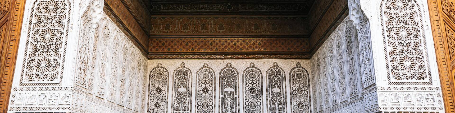 An ornate architectural interior with intricate tile work and detailed carvings.