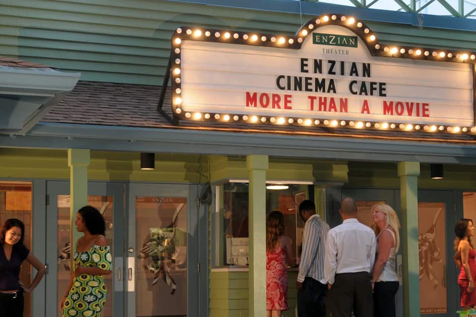A marquee with "ENZIAN CINEMA CAFE" and "MORE THAN A MOVIE" written on it.