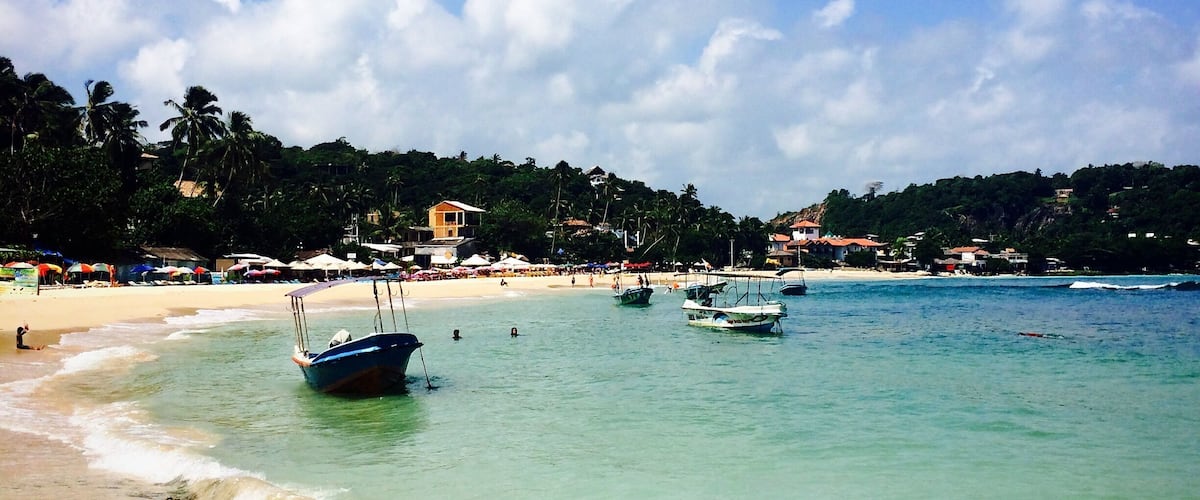 Unawatuna, Sri Lanka has most gorgeous tropical beach you could wish for. Located in a small bay so the waves are low and the water nice and warm. There are nice little cafes and restaurants lining the beach and friendly locals who can take you on a boat ride. #beach