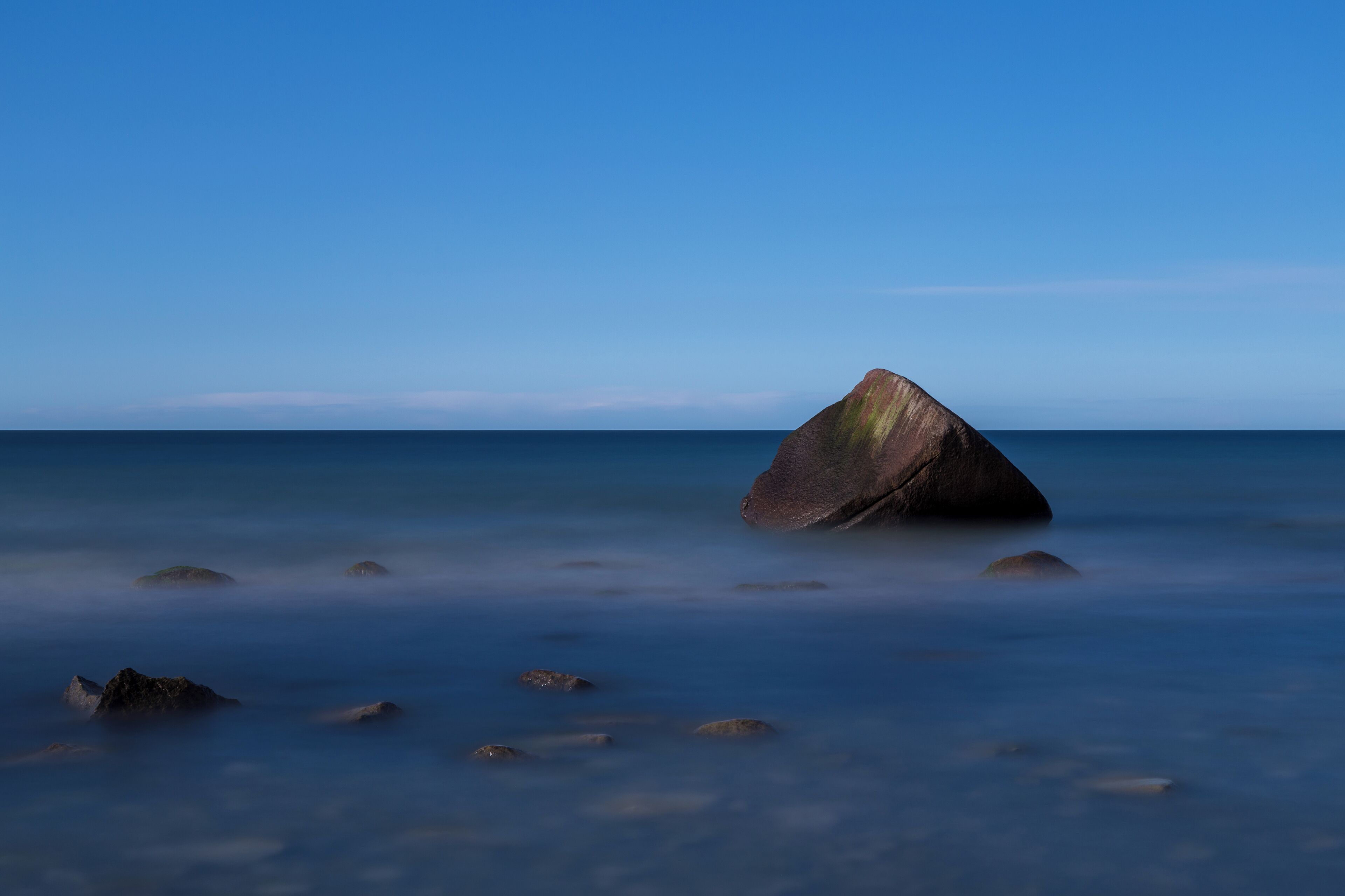 The so called Schwanenstein, a glacial erratic near the village of Lohme on the island of Rügen, Germany. On 13 February 1956, a sad story linked to the stone happened when three boys of the village of Lohme were playing at the shore of the frozen sea. Suddenly the weather changed and a storm broke the ice. The boys saved themselves on the stone. As the wind became a hurricane, local fishermen and border guards tried to save them, but they failed due to the heavy storm. The next morning, when the weather had calmed, the bodies of the three boys were recovered from the stone.